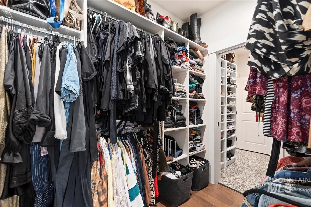 Spacious closet featuring light wood-style floors