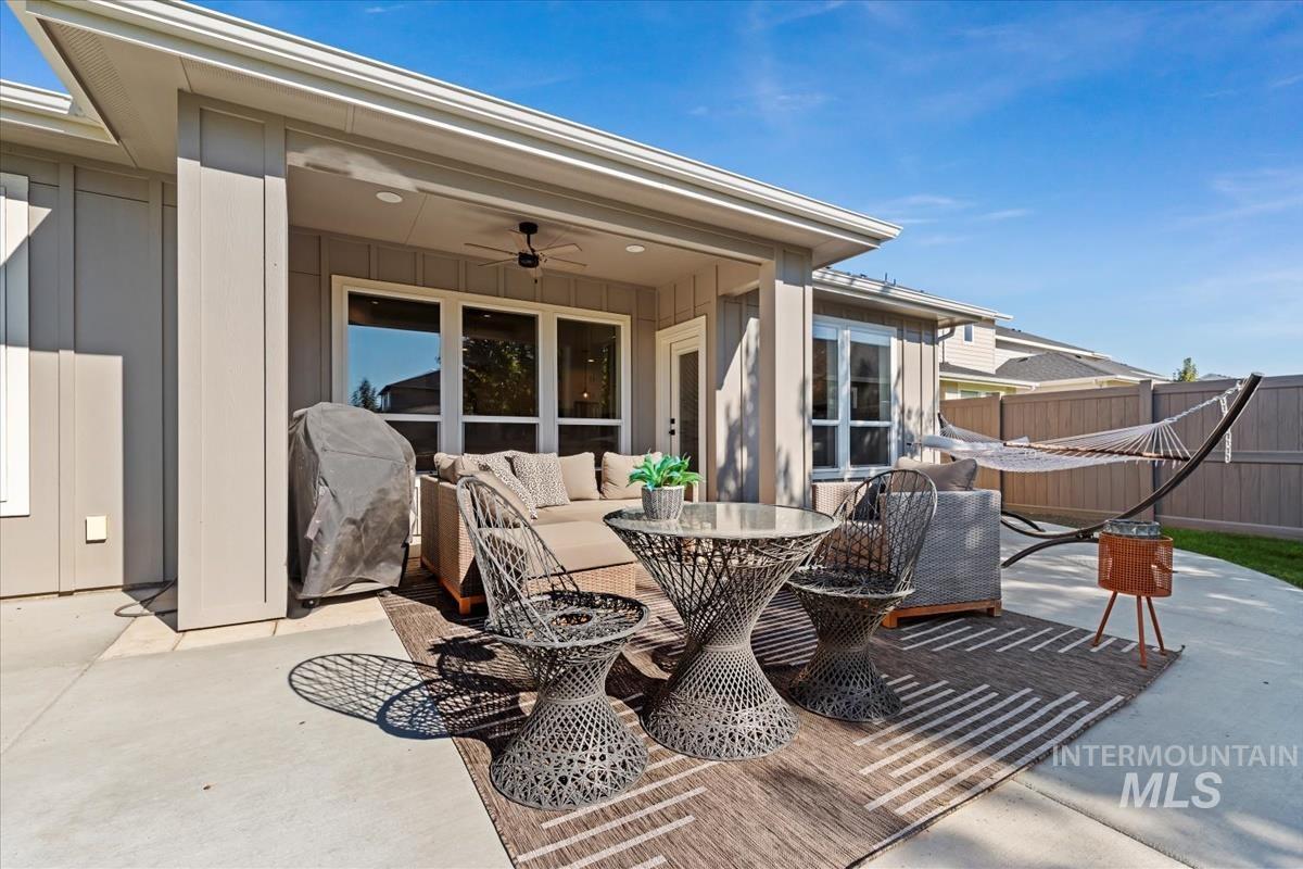 View of patio with a ceiling fan, an outdoor hangout area, and grilling area