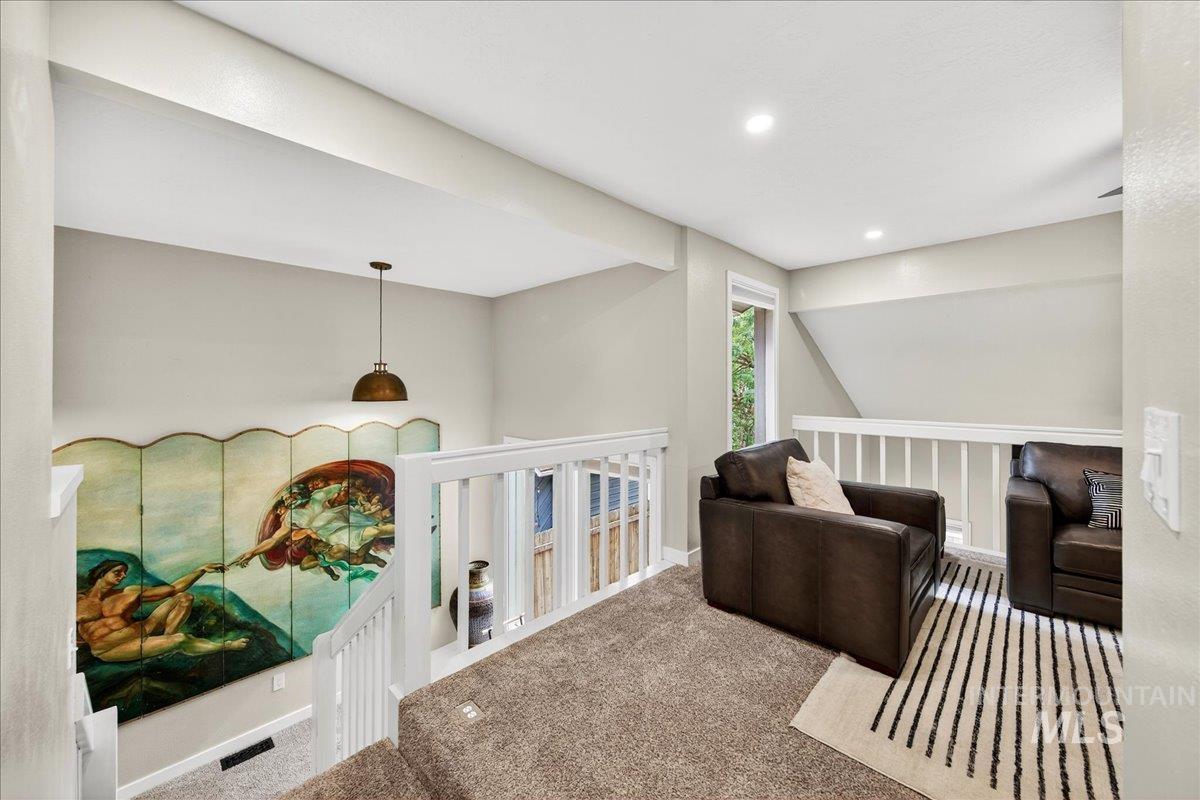 Sitting room featuring carpet floors, recessed lighting, and an upstairs landing