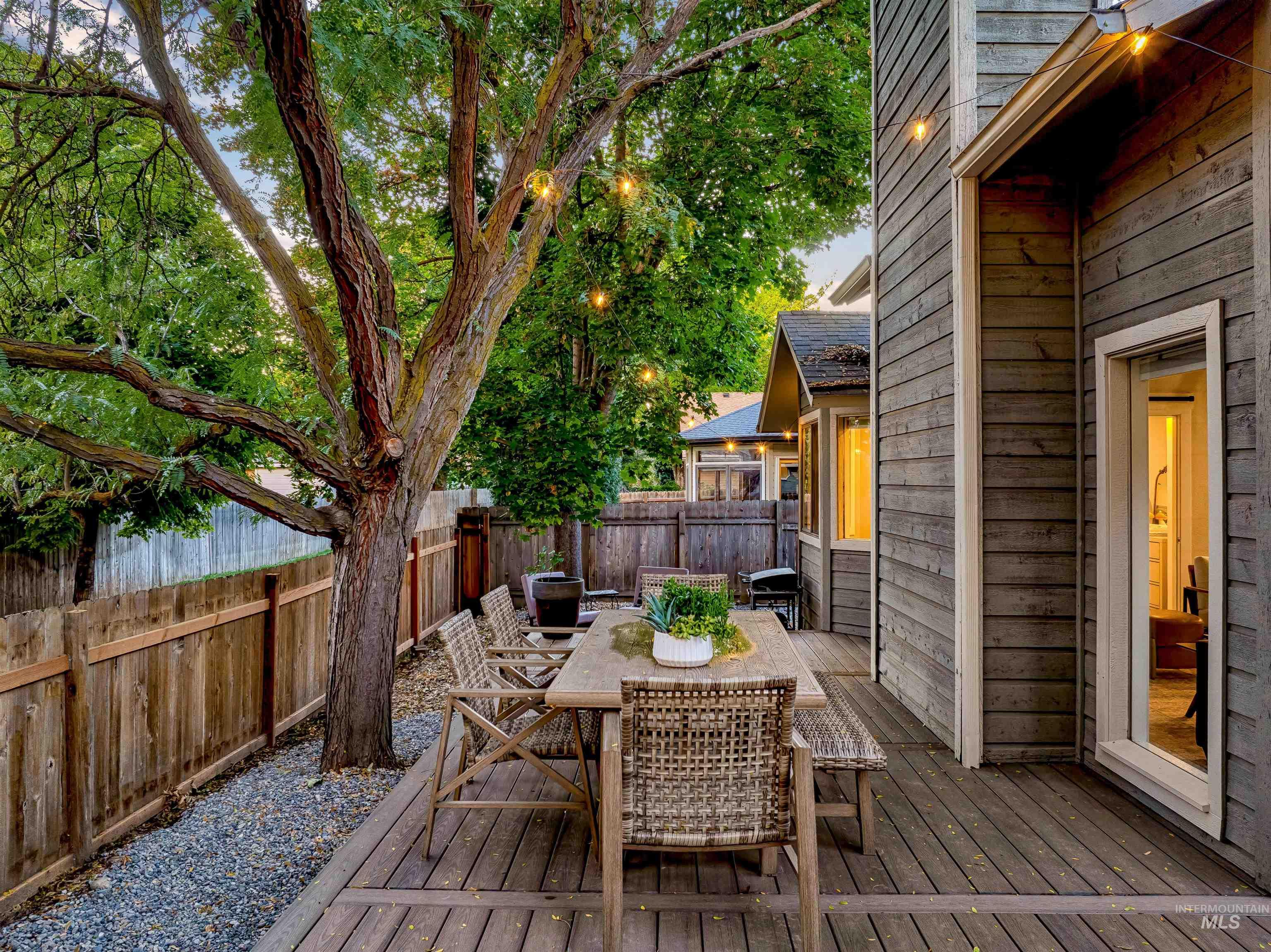 Wooden deck featuring outdoor dining space and a fenced backyard