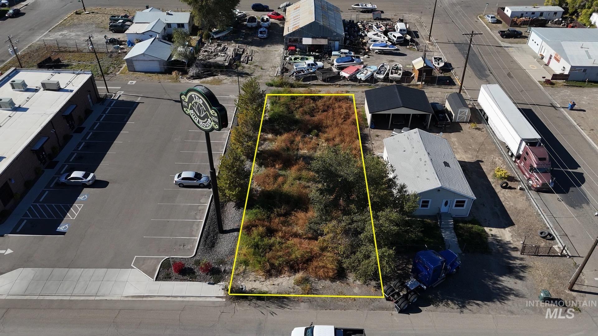 Aerial view of property and surrounding area featuring property boundaries highlighted