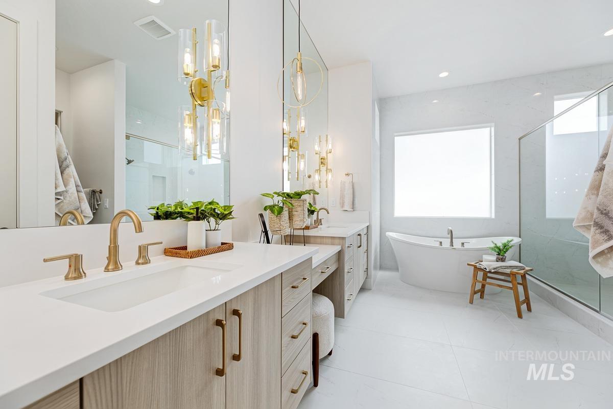 Bathroom with two vanities, a soaking tub, a stall shower, recessed lighting, and light tile patterned floors