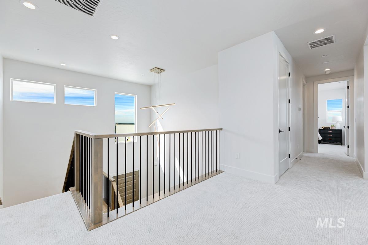 Corridor featuring recessed lighting, carpet, and an upstairs landing