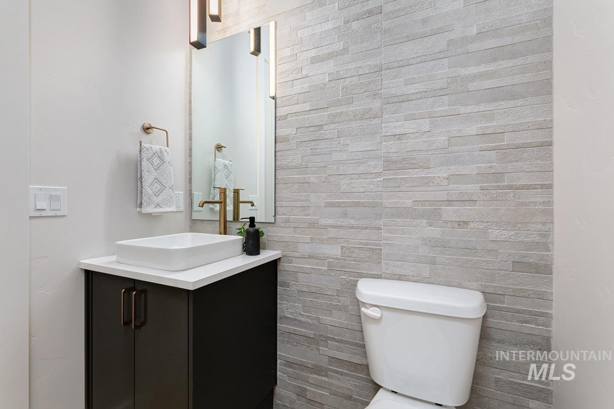 Half bath featuring vanity and toilet