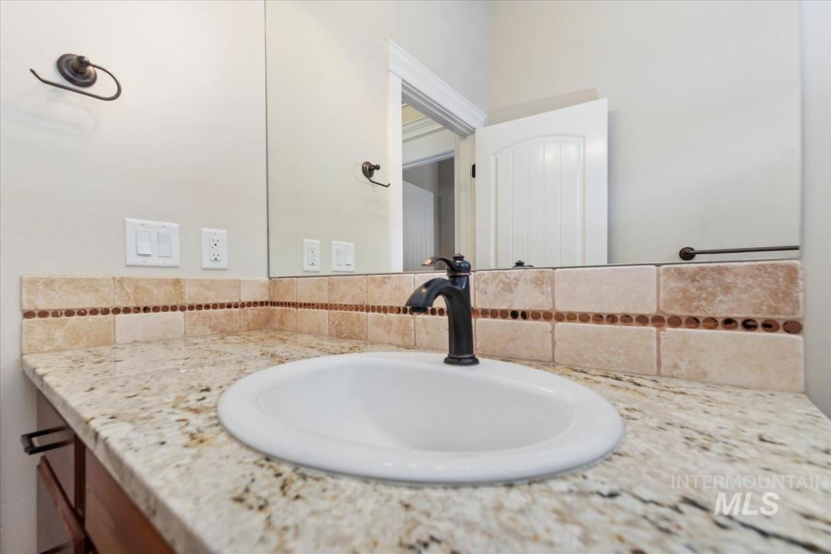 Bathroom with vanity and backsplash