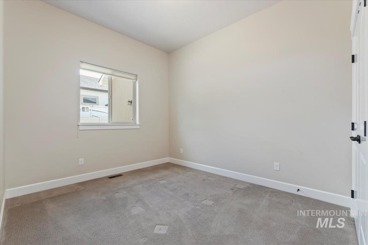 Empty room with carpet floors and baseboards