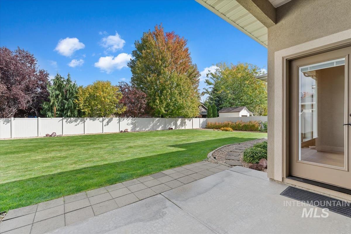 Fenced backyard with a patio