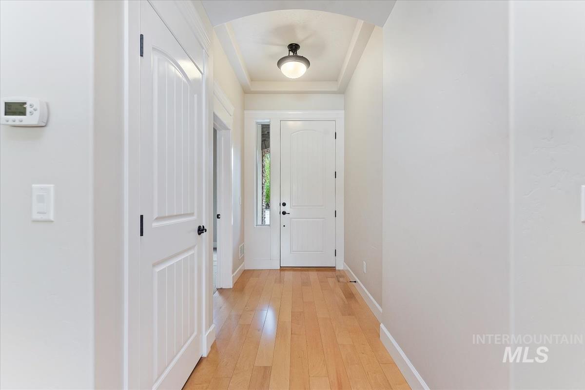 Doorway to outside with wood-type flooring and arched walkways