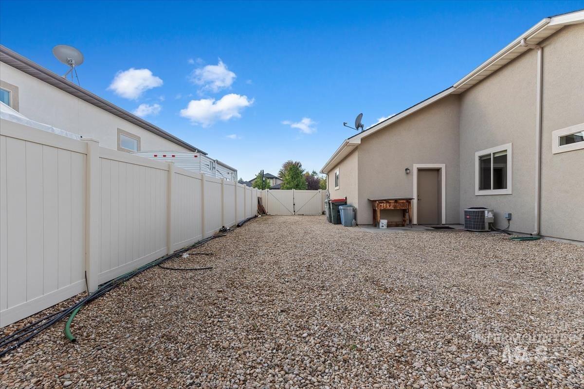 Fenced backyard featuring a patio and a gate