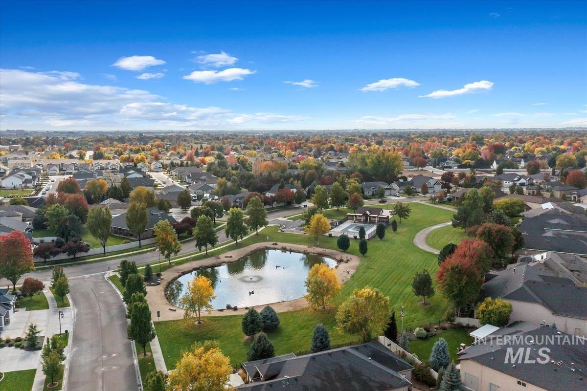 Aerial view of residential area featuring a nearby body of water