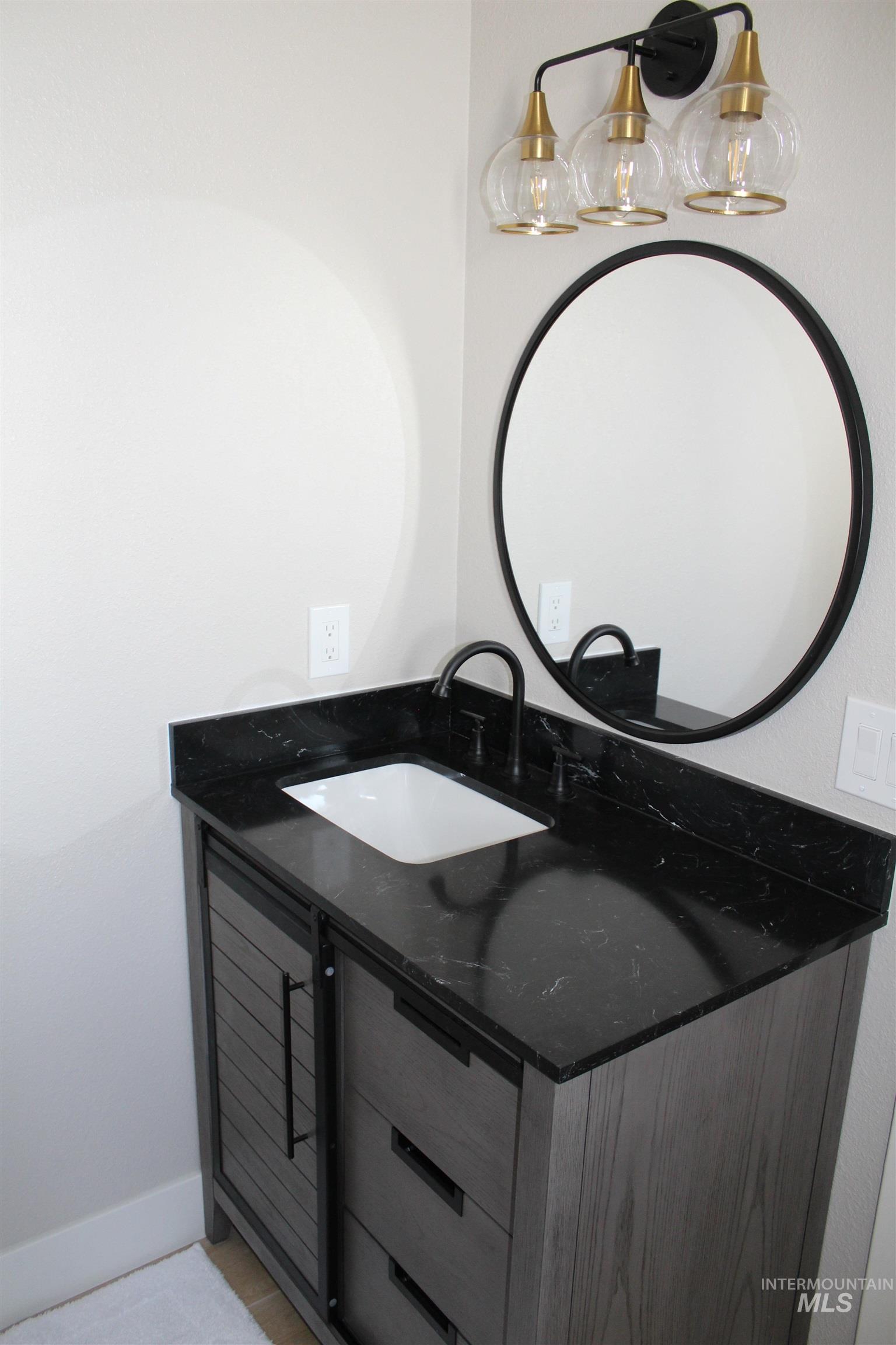 Bathroom with vanity and baseboards