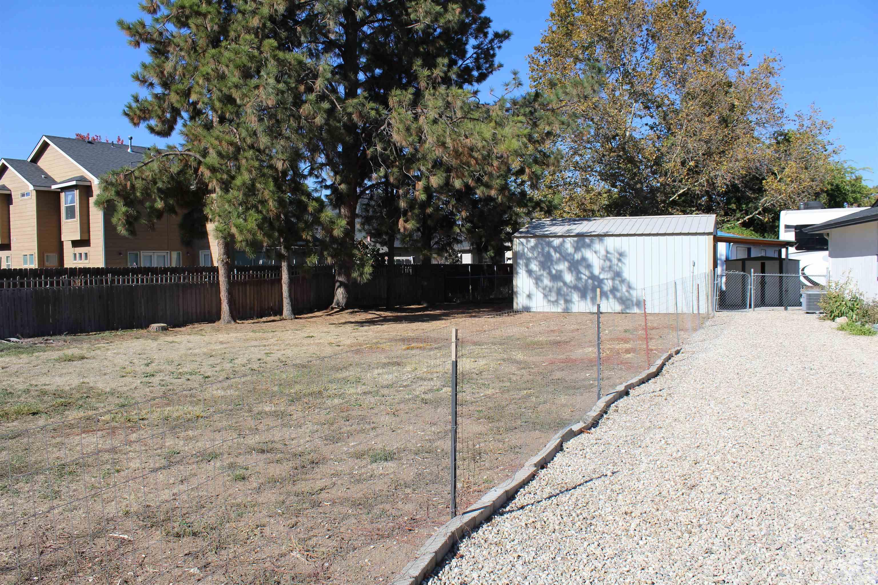 Fenced backyard featuring an outdoor structure