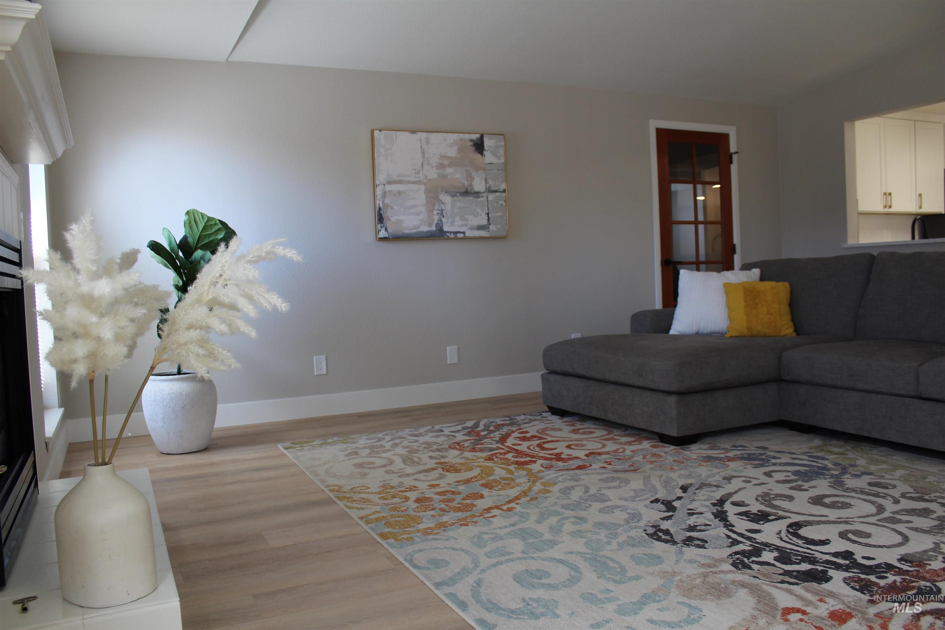 Living area with light wood-style floors and baseboards