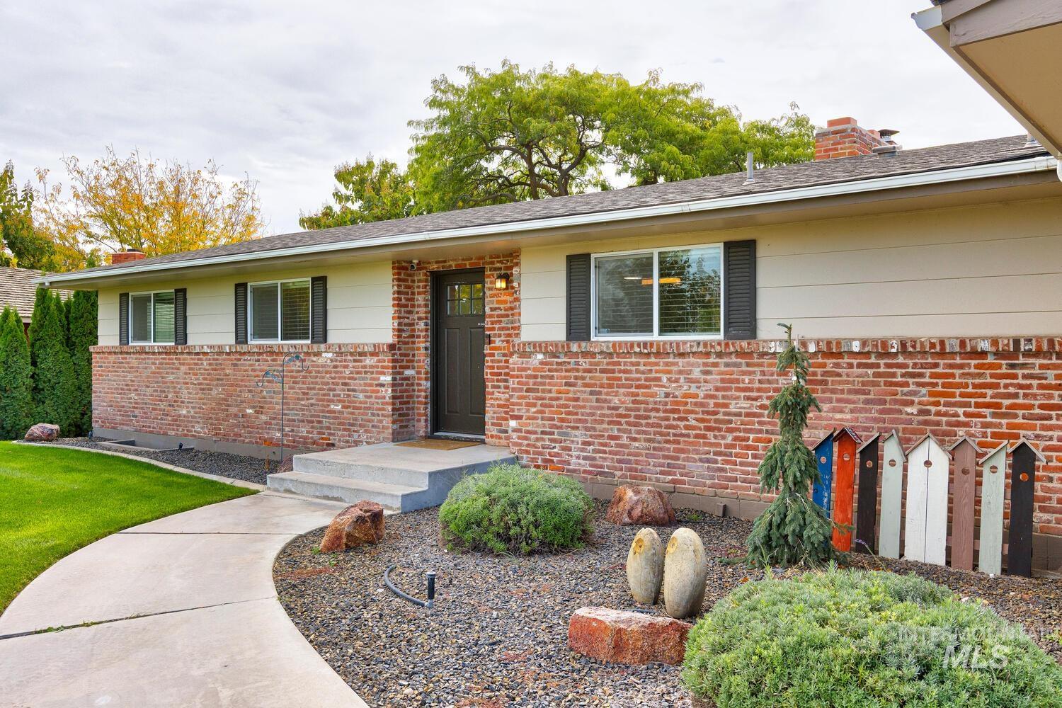 Single story home with brick siding and a chimney