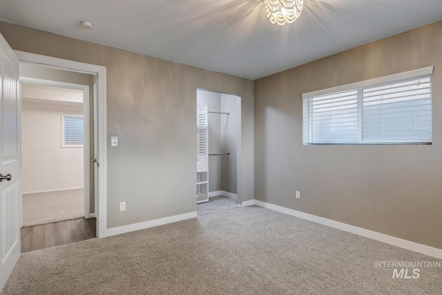 Unfurnished bedroom with light colored carpet and a closet