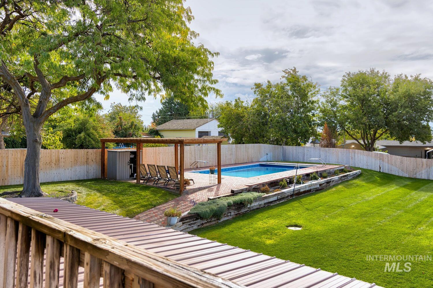View of swimming pool with a fenced backyard and a patio area