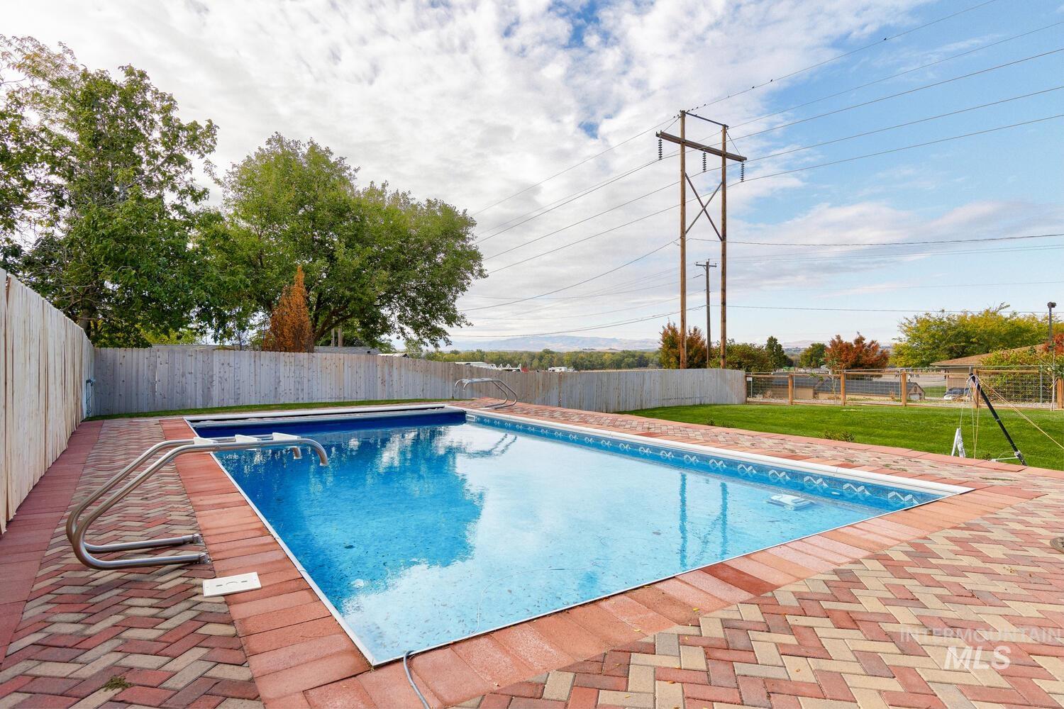 View of pool with a fenced backyard and a patio area