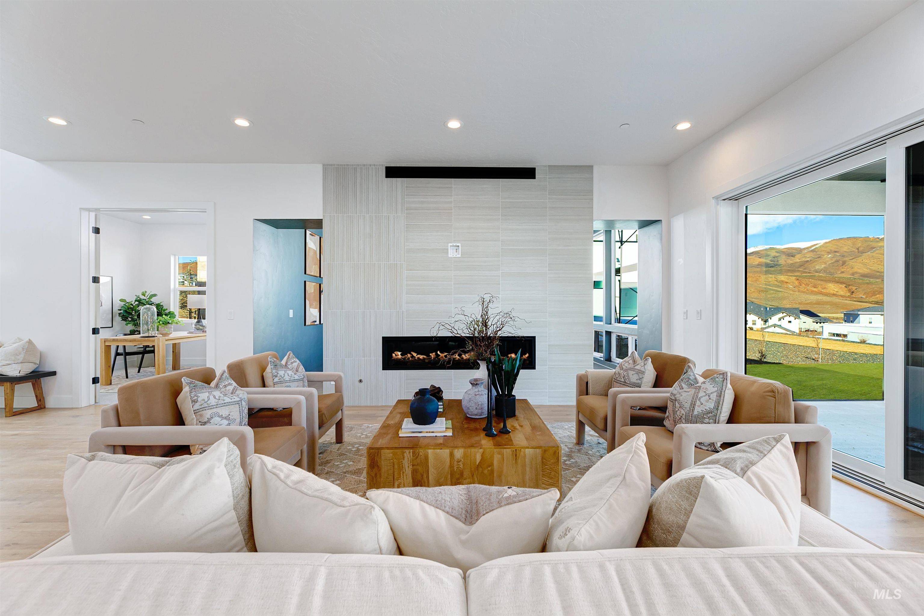 Living room featuring recessed lighting, a fireplace, and wood finished floors