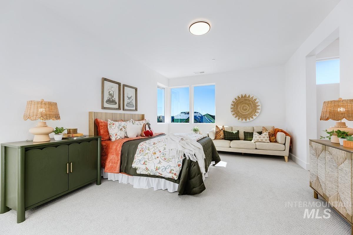 Carpeted bedroom featuring multiple windows