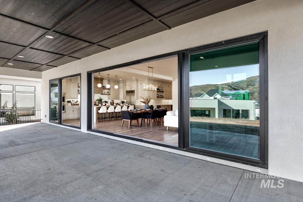 Entrance to property featuring stucco siding and a patio