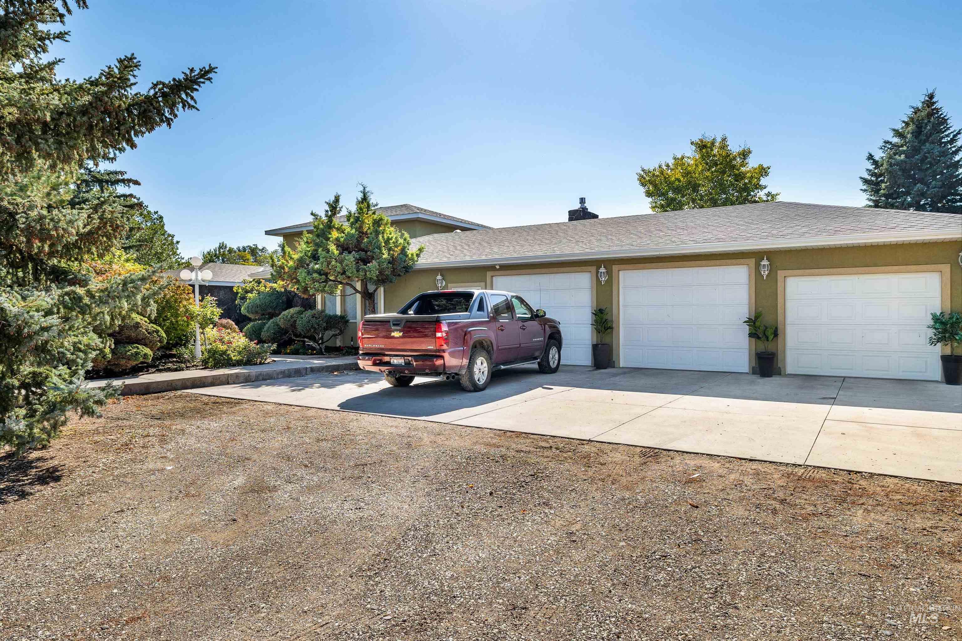 View of front of home featuring concrete driveway, an attached garage, roof with shingles, and stucco siding