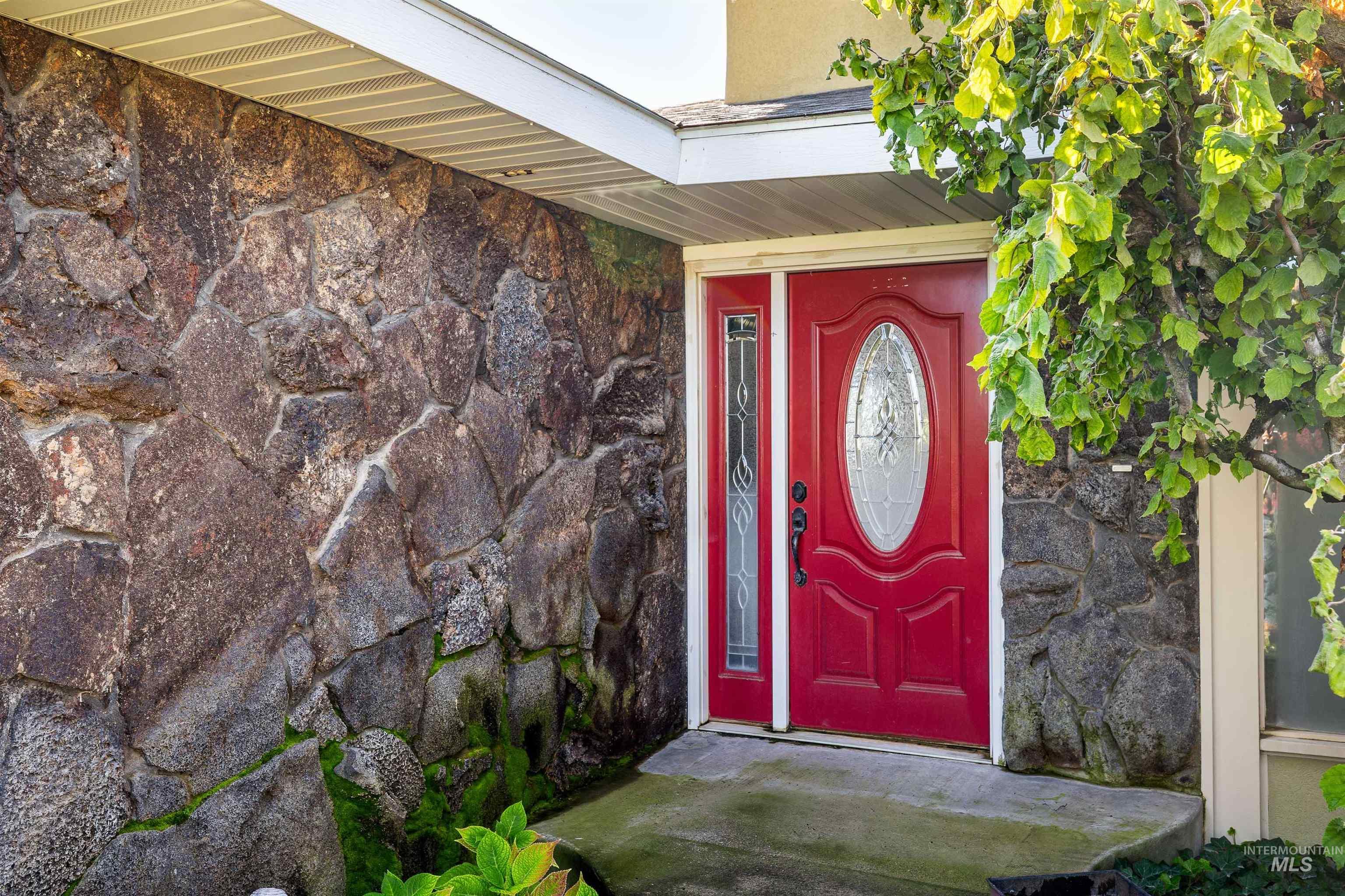 Entrance to property with stone siding