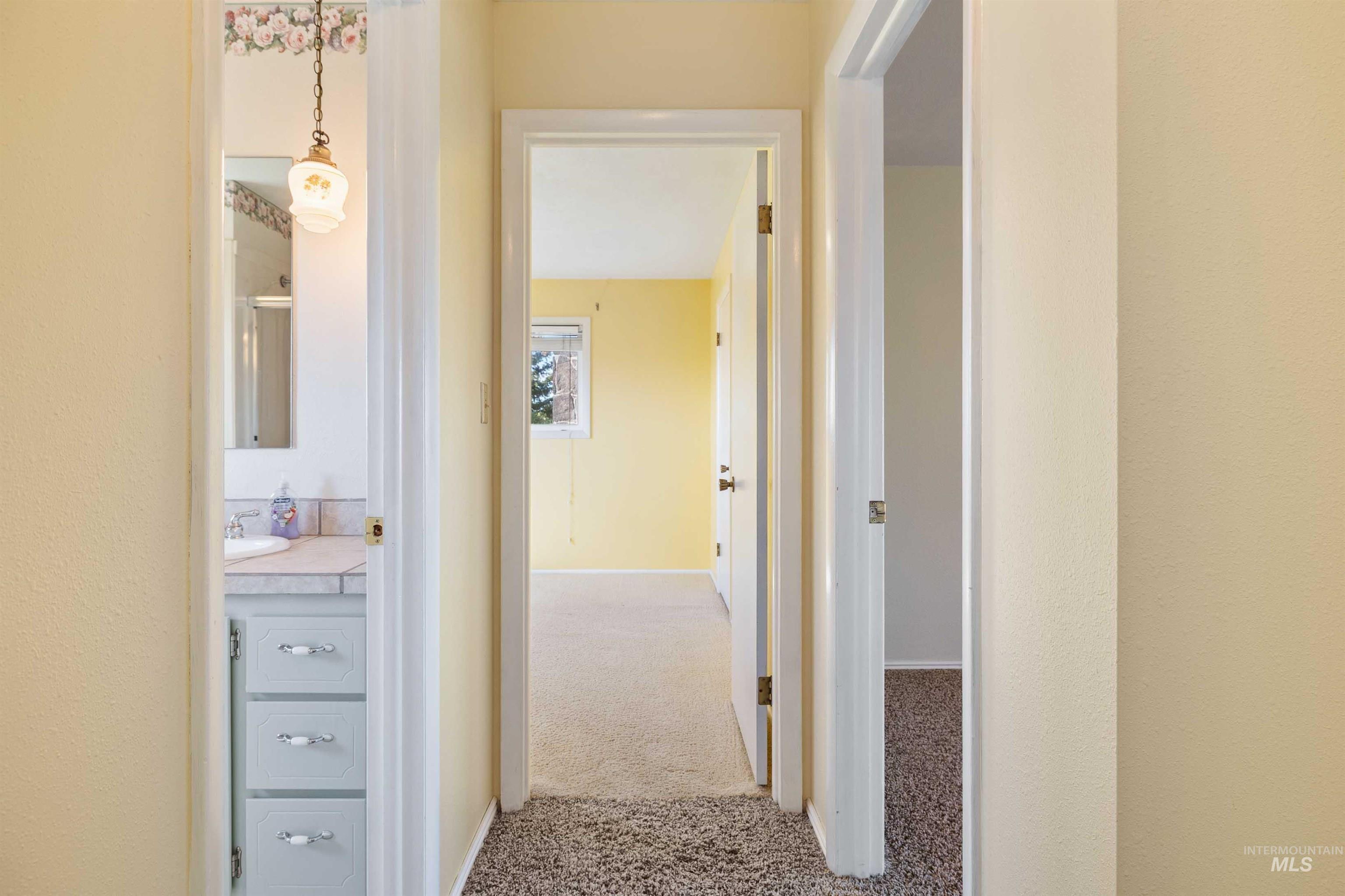 Corridor with carpet and baseboards