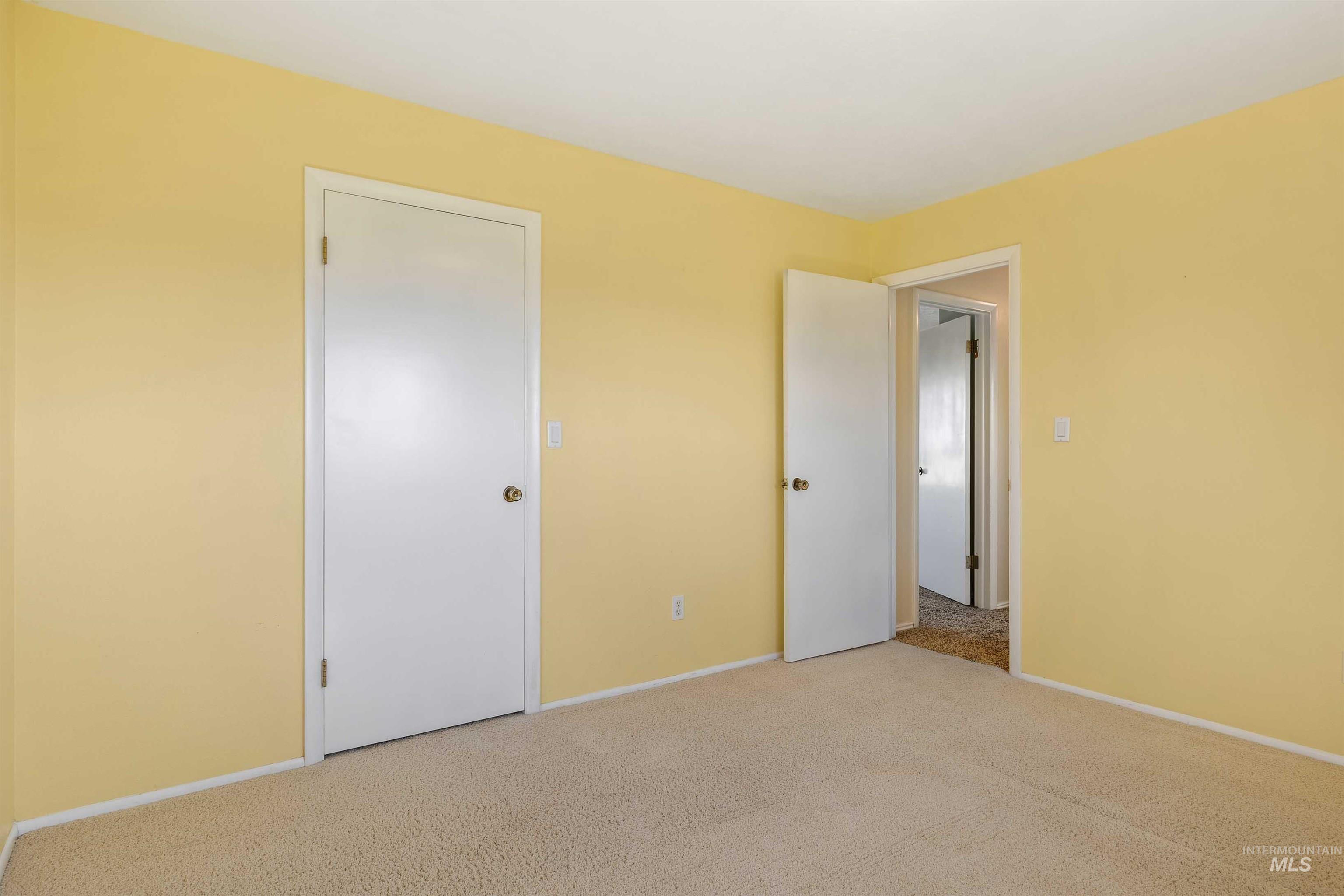 Unfurnished bedroom featuring carpet floors and baseboards