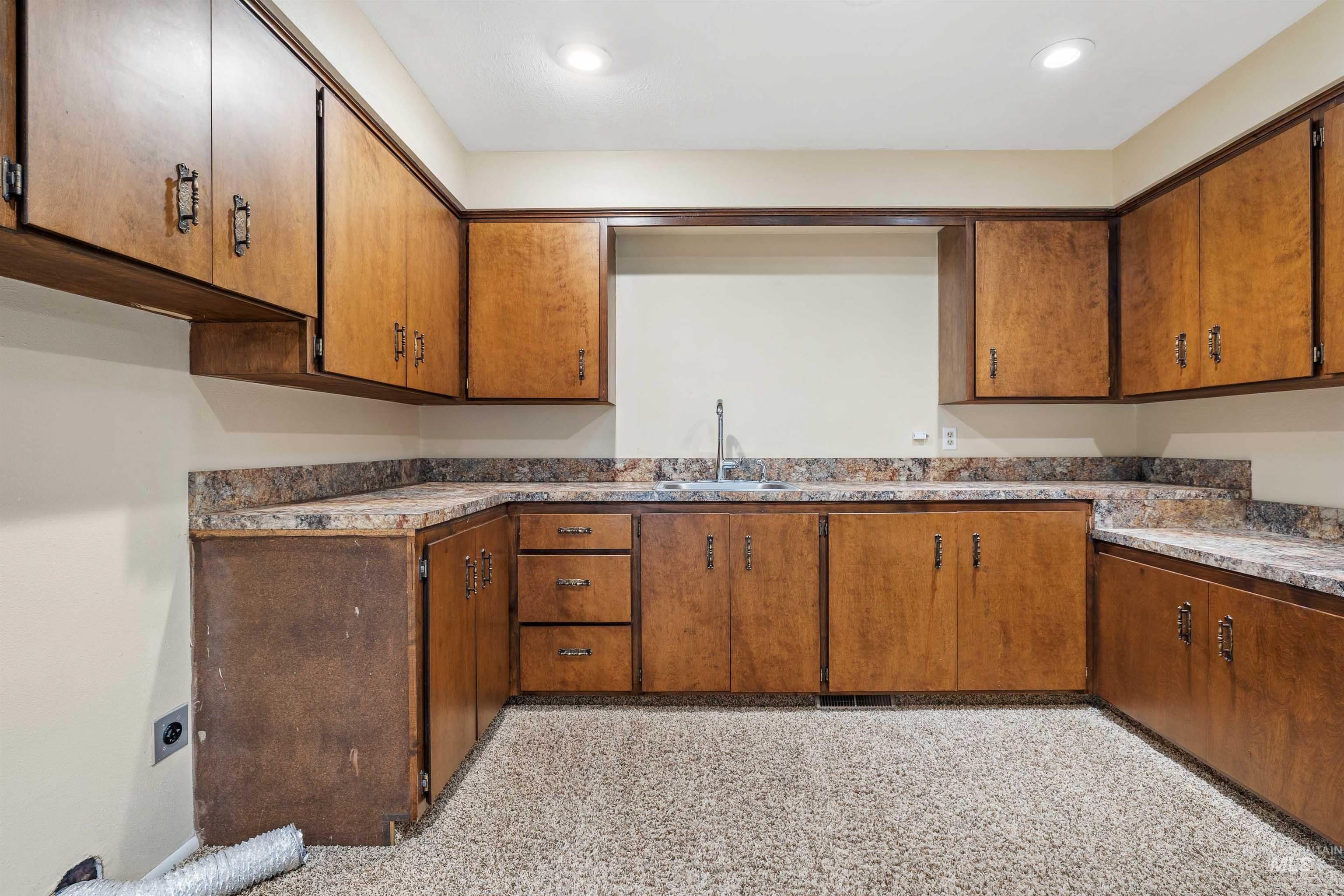 Kitchen with brown cabinets and recessed lighting