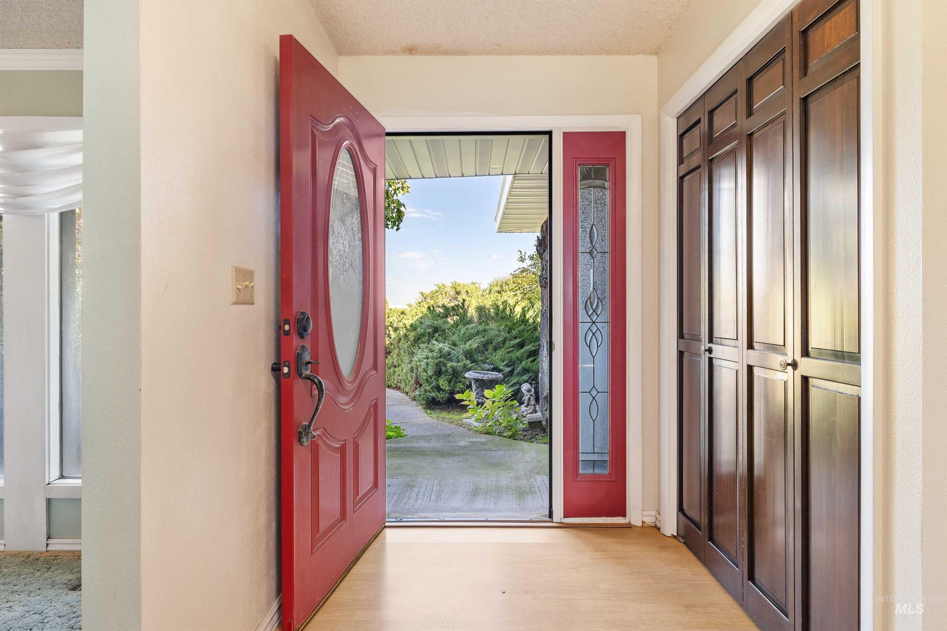 Foyer featuring light wood-style flooring and a textured ceiling