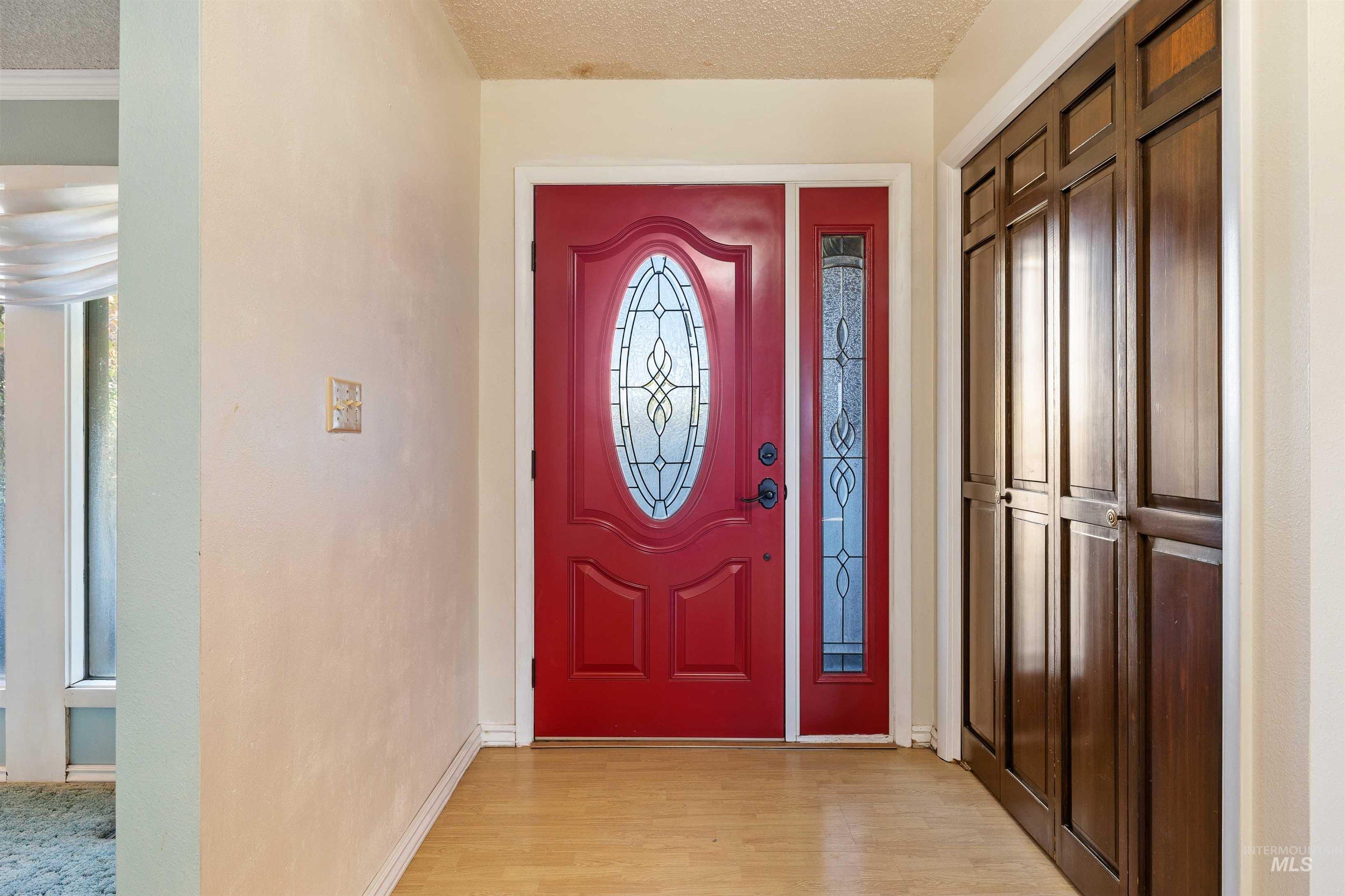 Foyer featuring a textured ceiling and light wood-style flooring