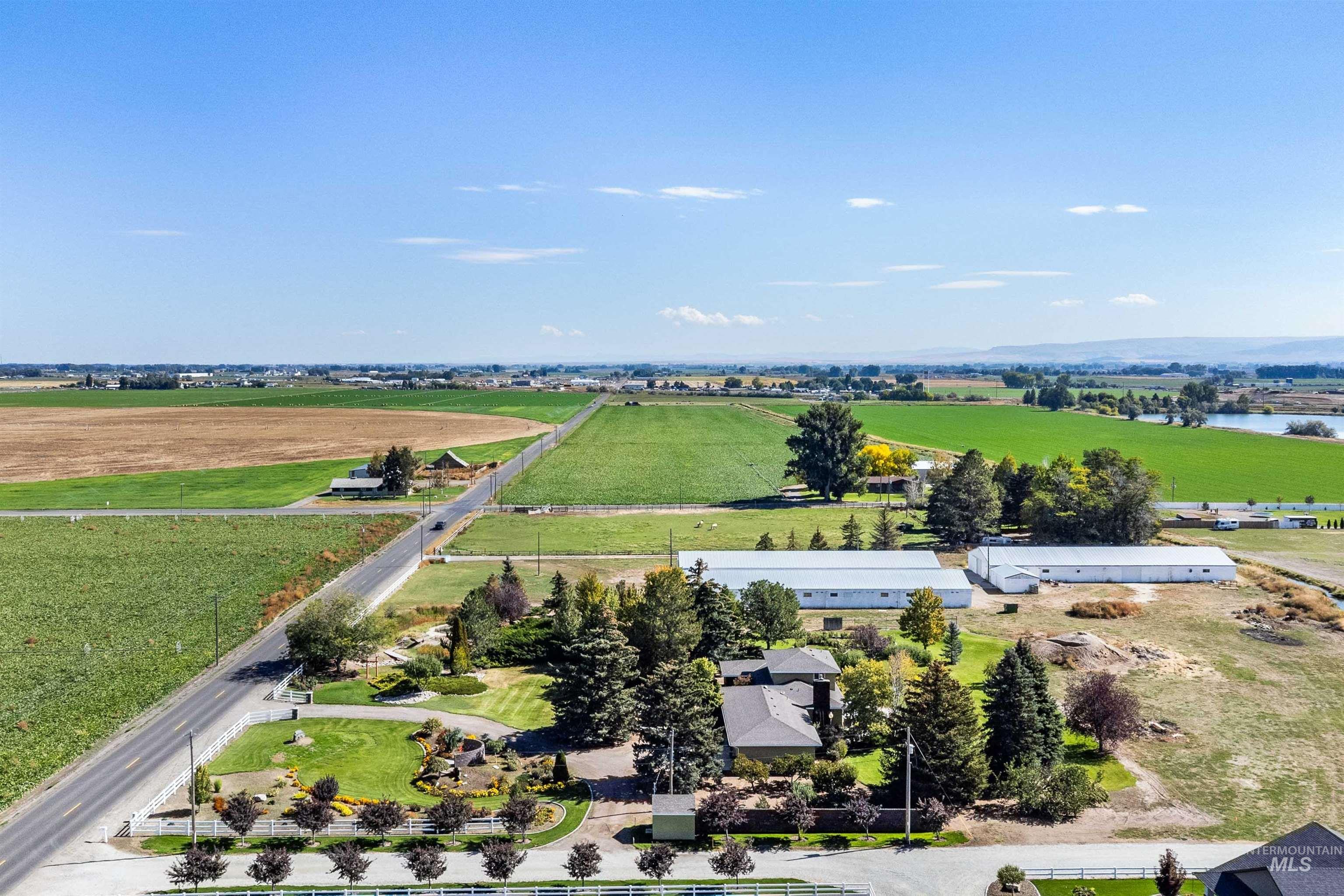 Aerial view of sparsely populated area with rows of crops