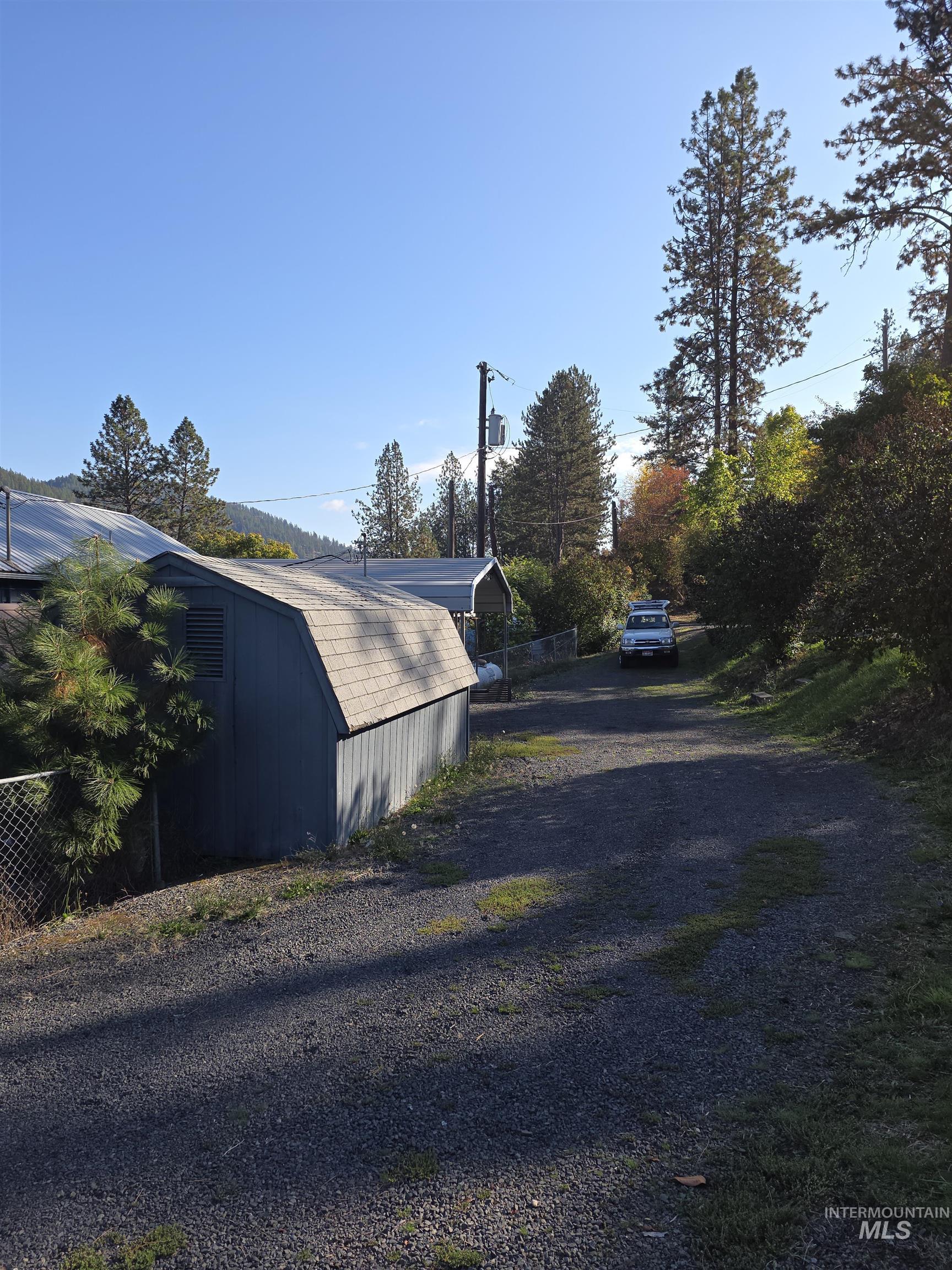 View of home's exterior featuring an outdoor structure and driveway