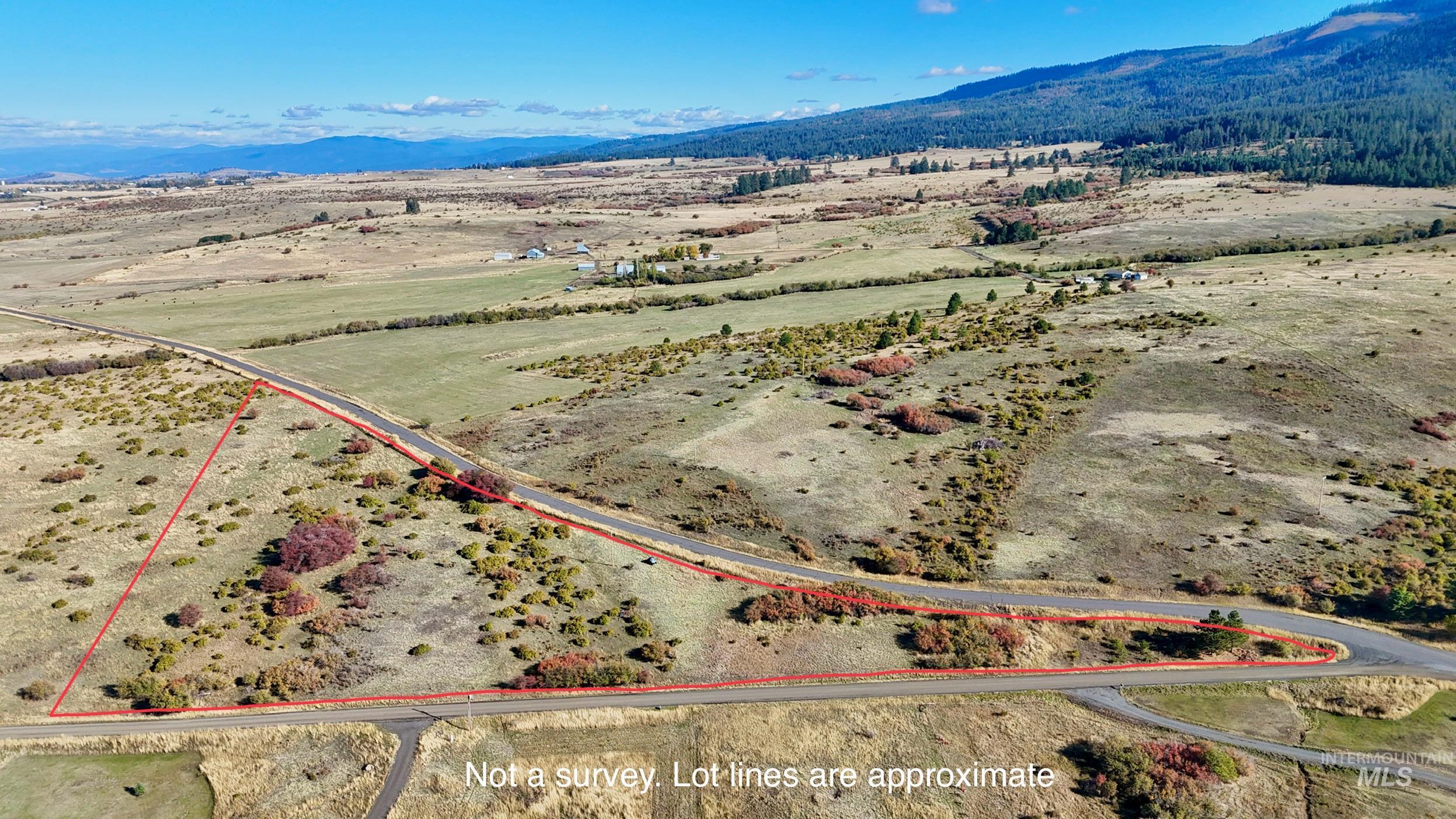 View of rural area with property parcel outlined and mountains
