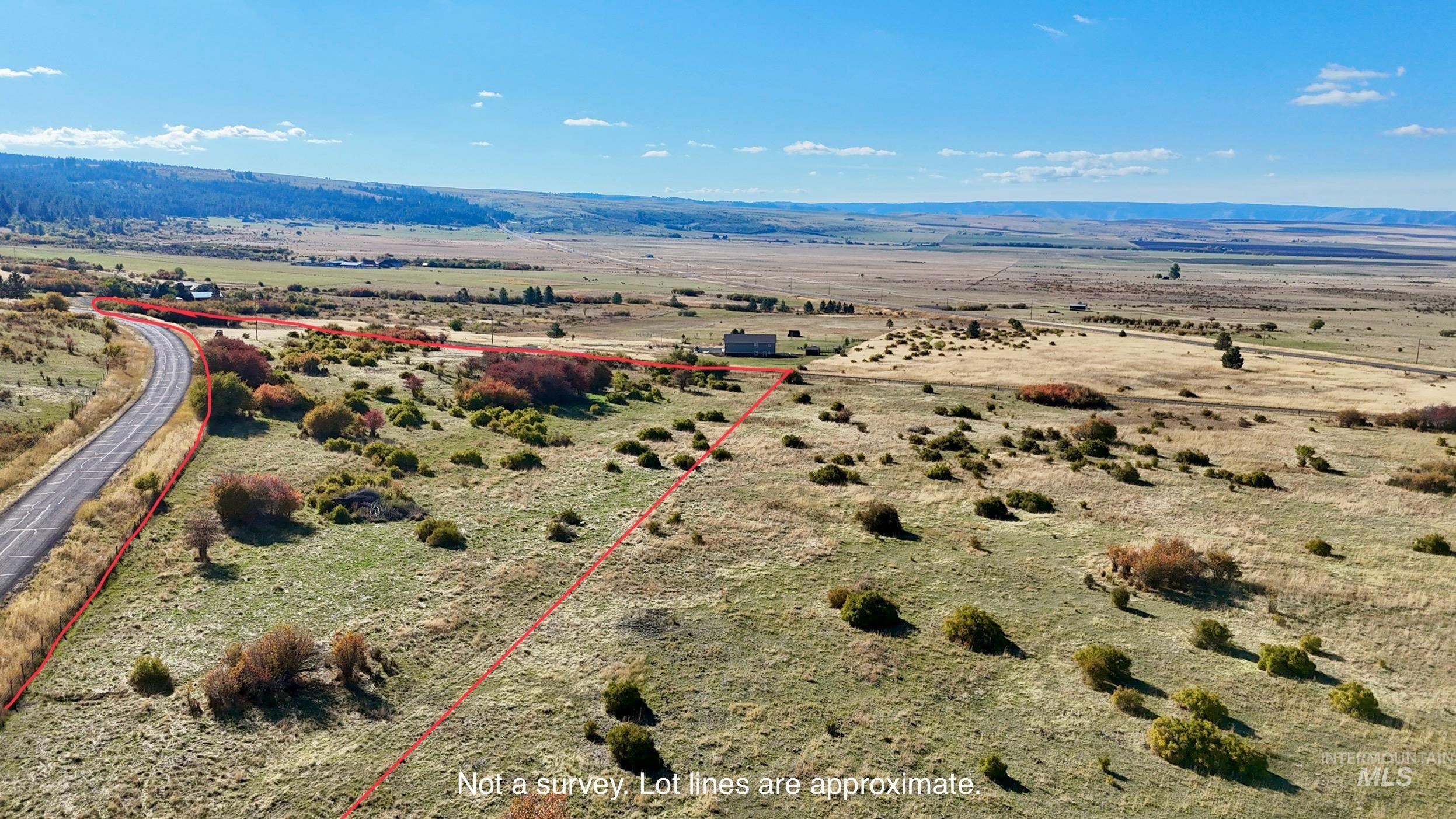 View of rural area featuring property parcel outlined and a mountainous background