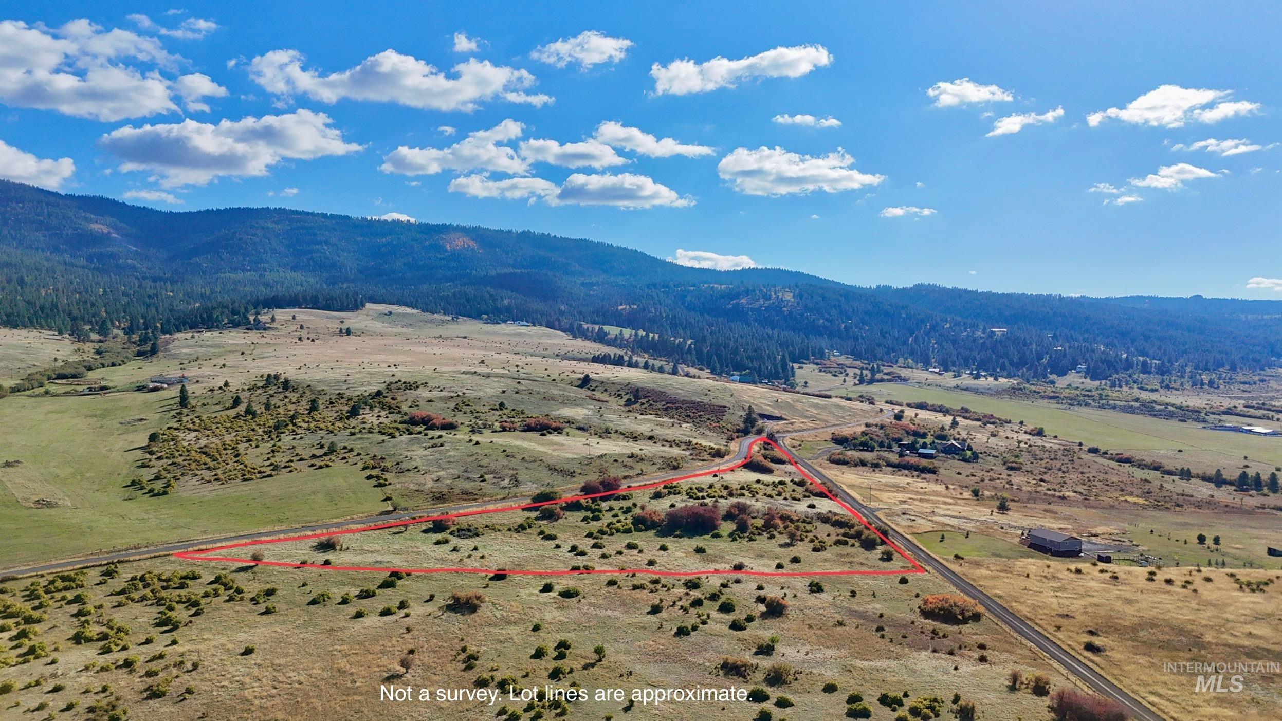 View of rural area with property parcel outlined and a mountainous background