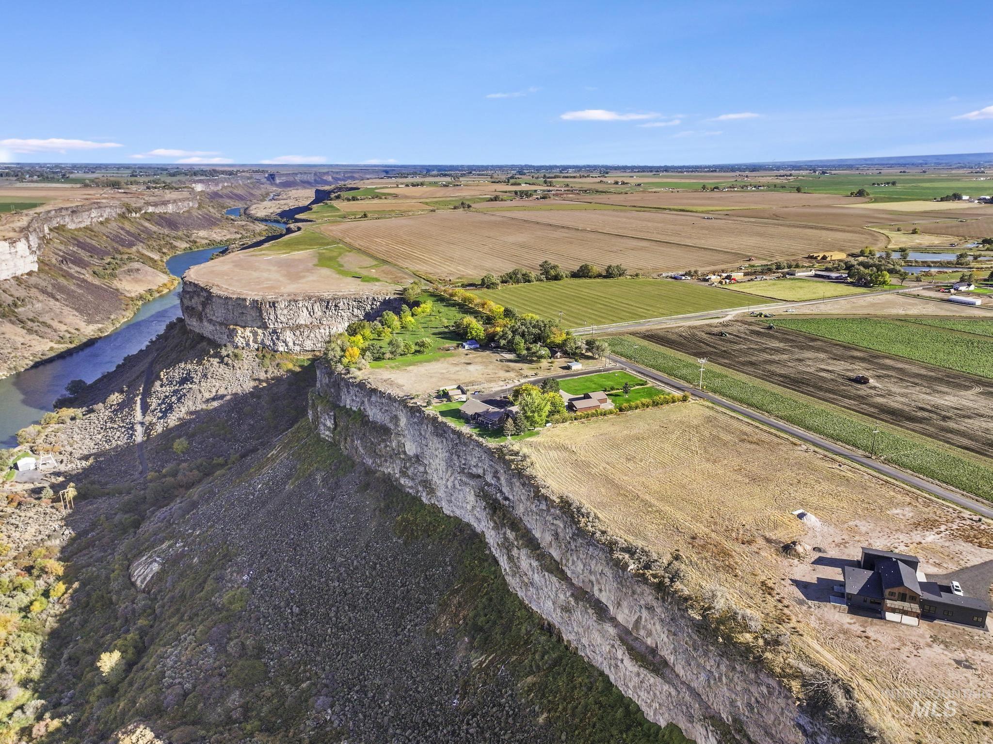 Aerial view of sparsely populated area with rows of crops