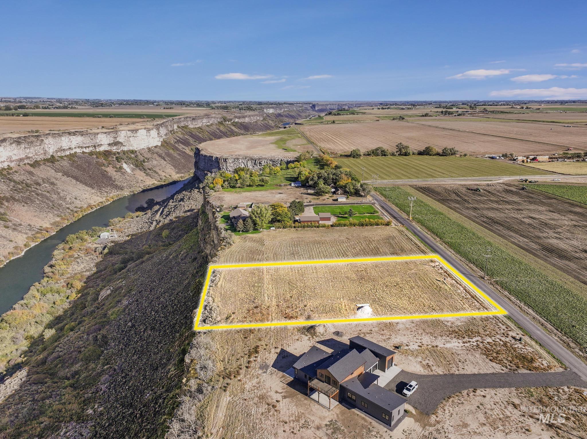 Aerial view of sparsely populated area featuring property parcel outlined and farmland