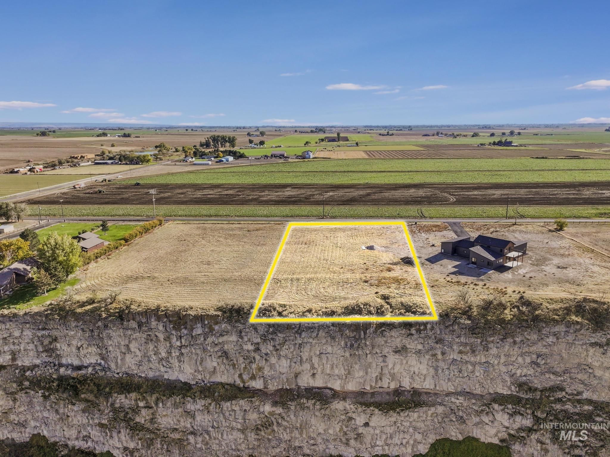 Aerial view of sparsely populated area featuring property boundaries highlighted and extensive farmland