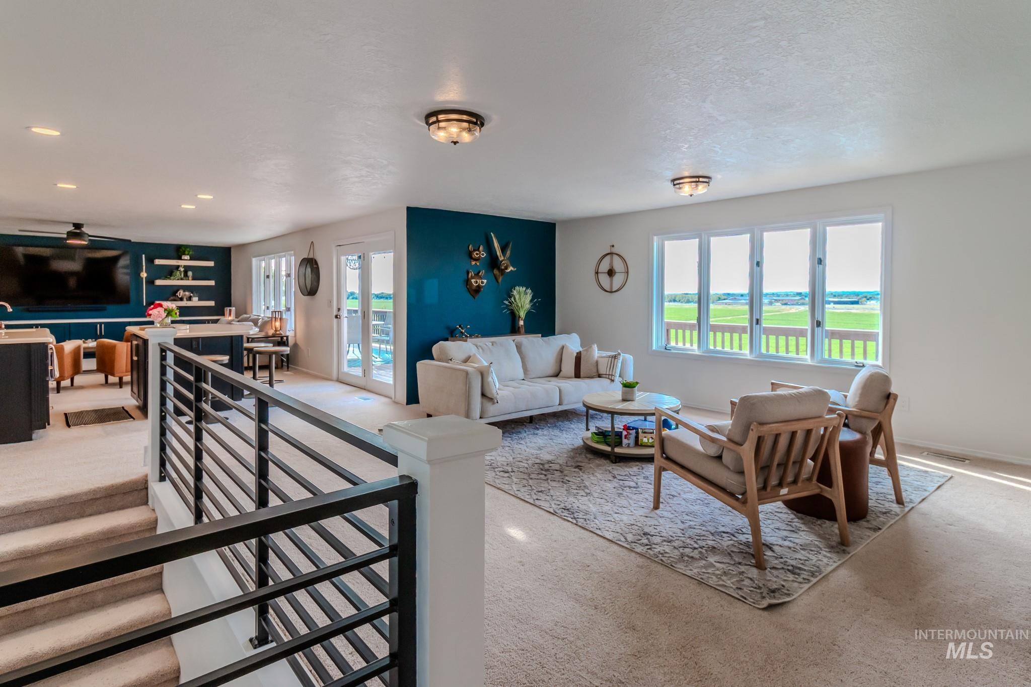 Living area with plenty of natural light, recessed lighting, and ceiling fan