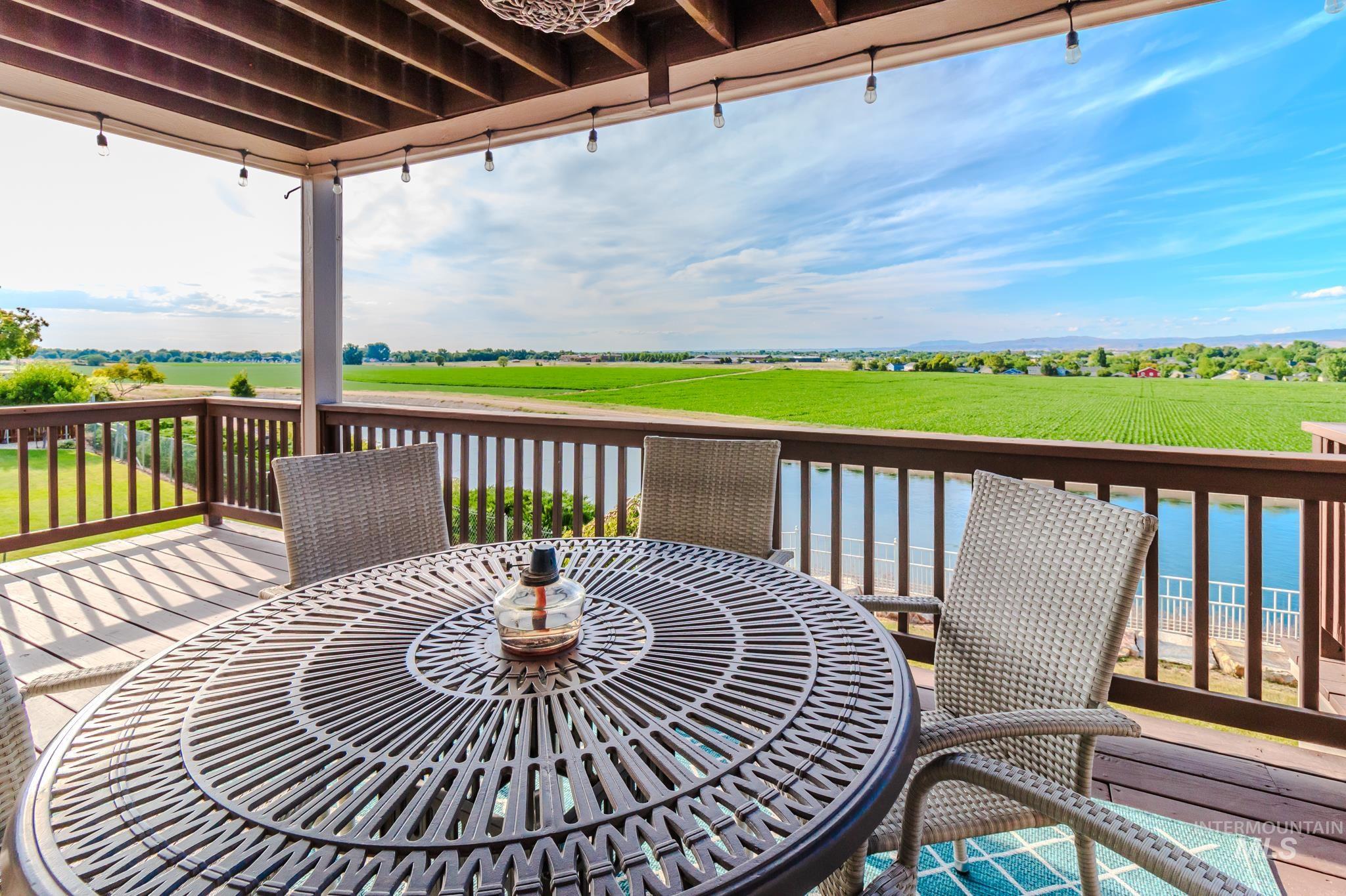 Wooden deck featuring outdoor dining space and a view of countryside