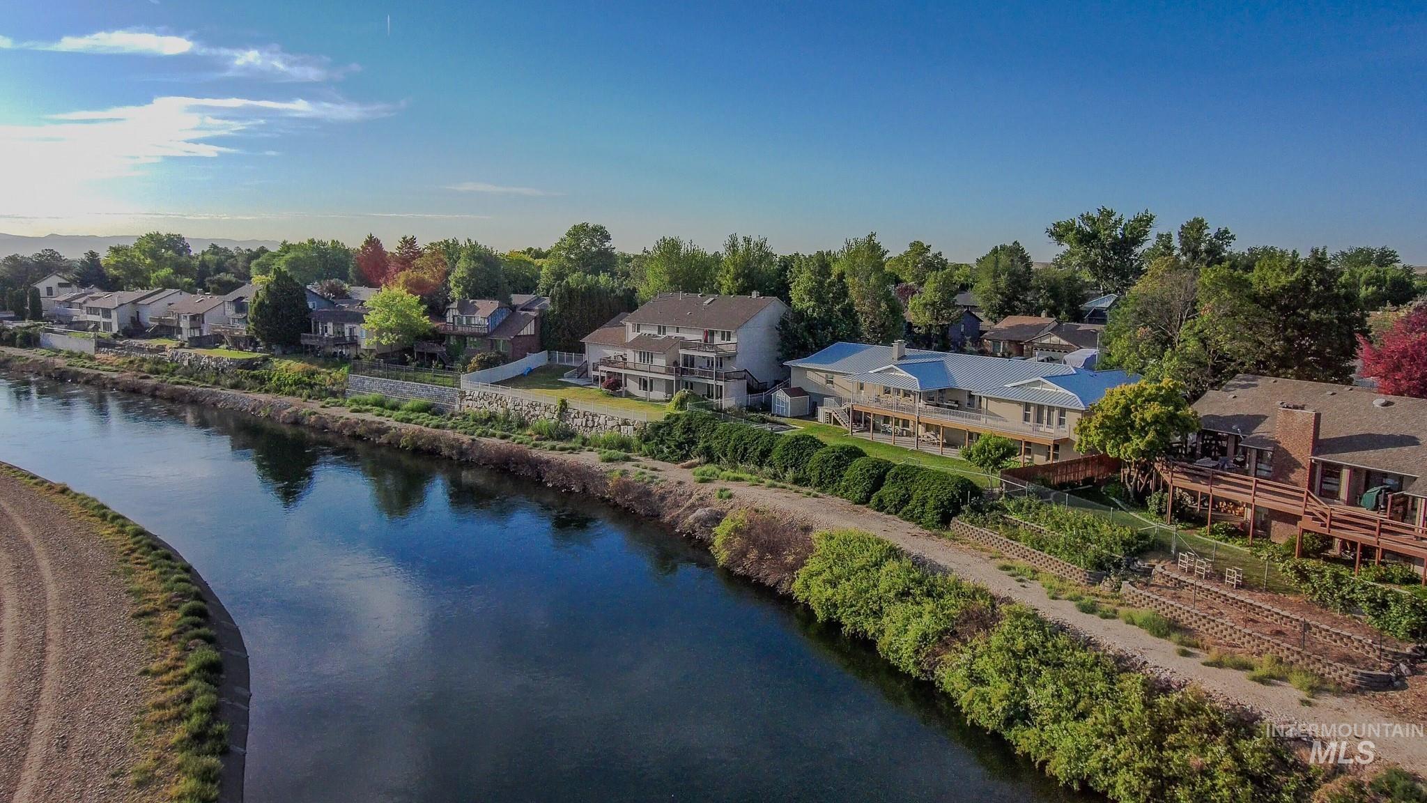 Aerial perspective of suburban area featuring a large body of water