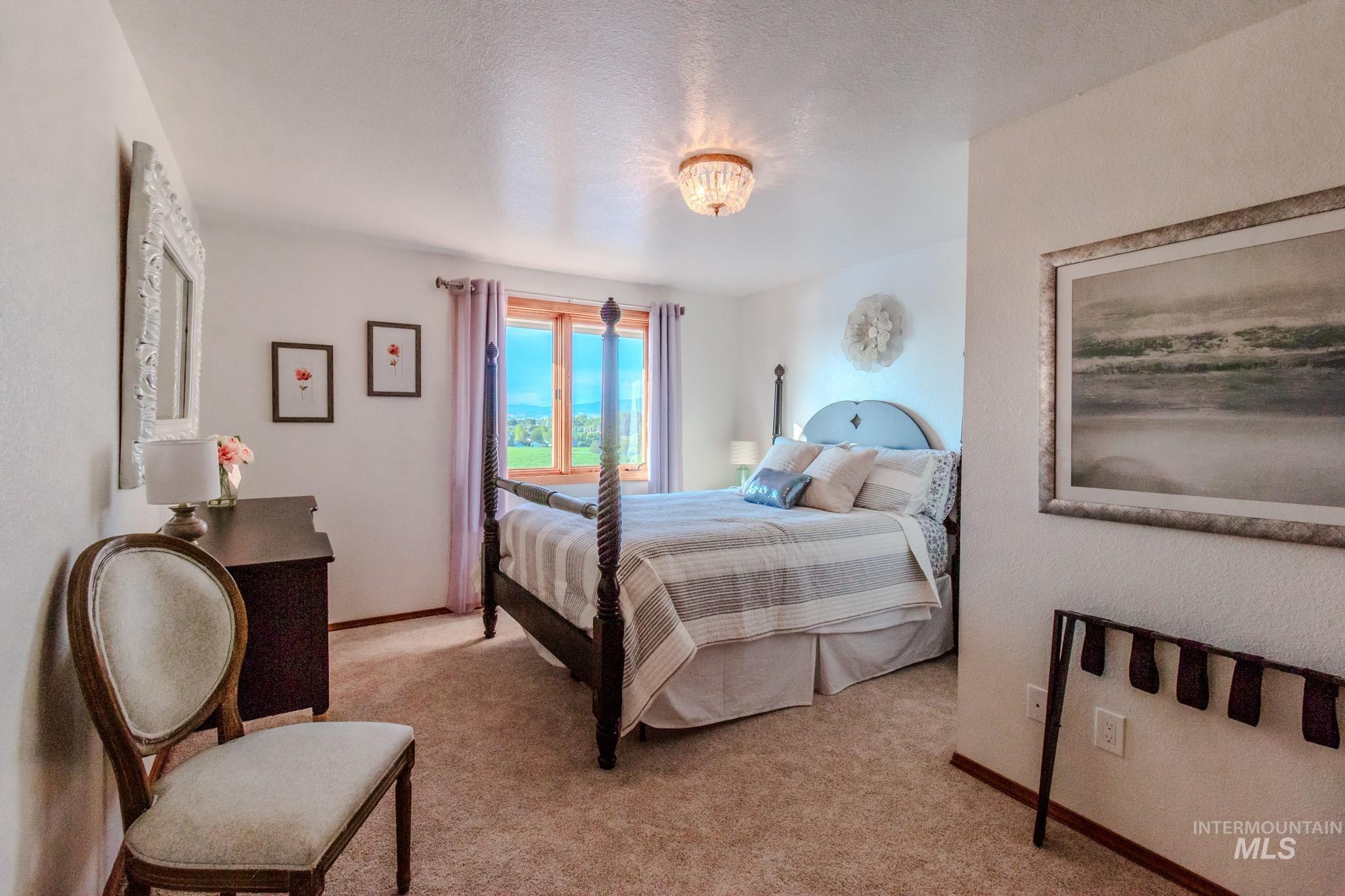 Bedroom with light carpet and baseboards