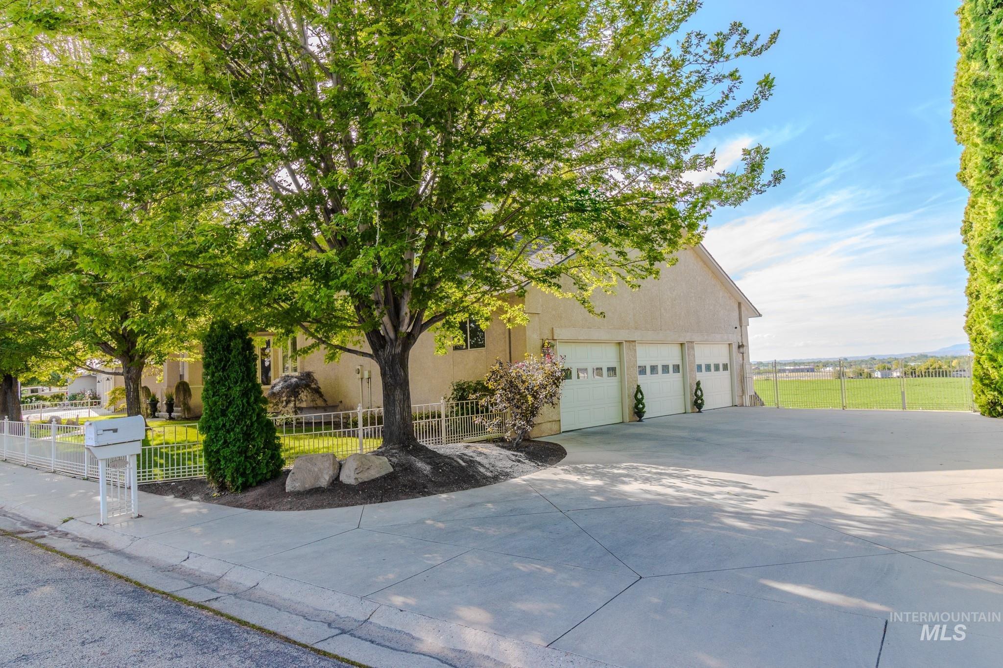 View of front of property featuring stucco siding and concrete driveway