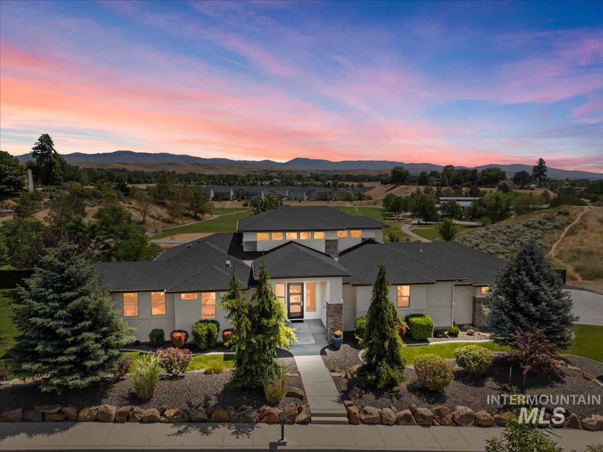 View of front of house featuring a mountain view and concrete driveway