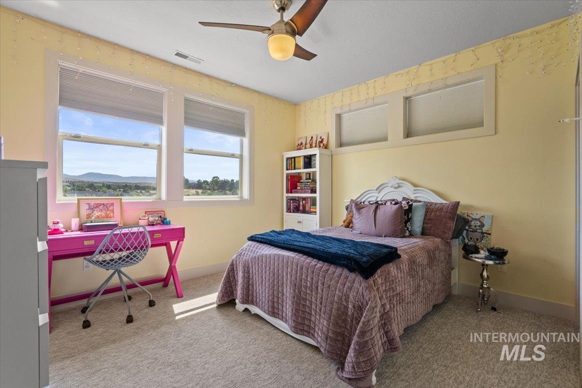 Bedroom with carpet floors and ceiling fan