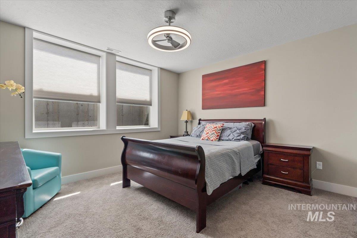 Bedroom with carpet and a textured ceiling