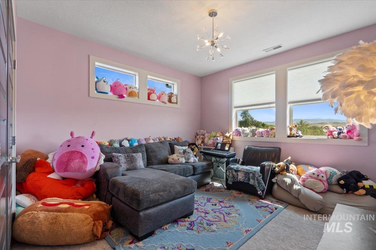 Living room featuring a chandelier and carpet