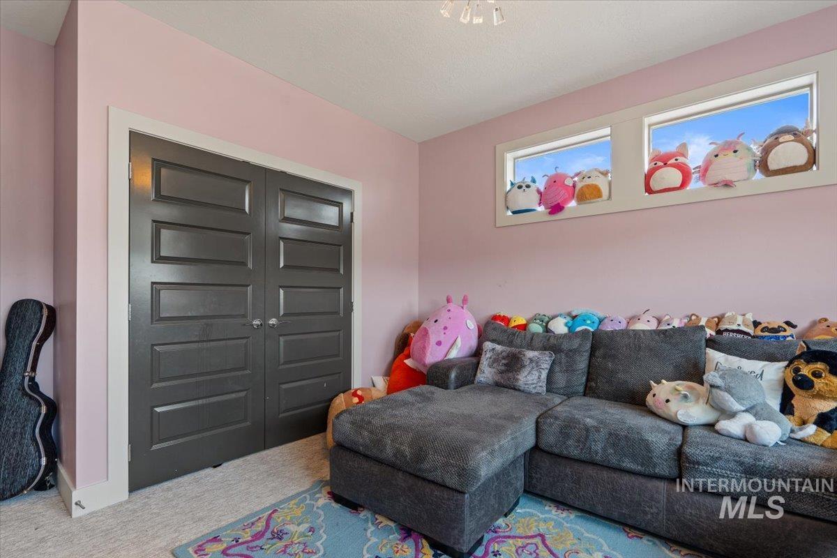 Carpeted living room with baseboards