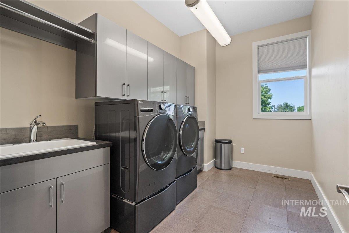 Laundry room featuring cabinet space and washer and clothes dryer